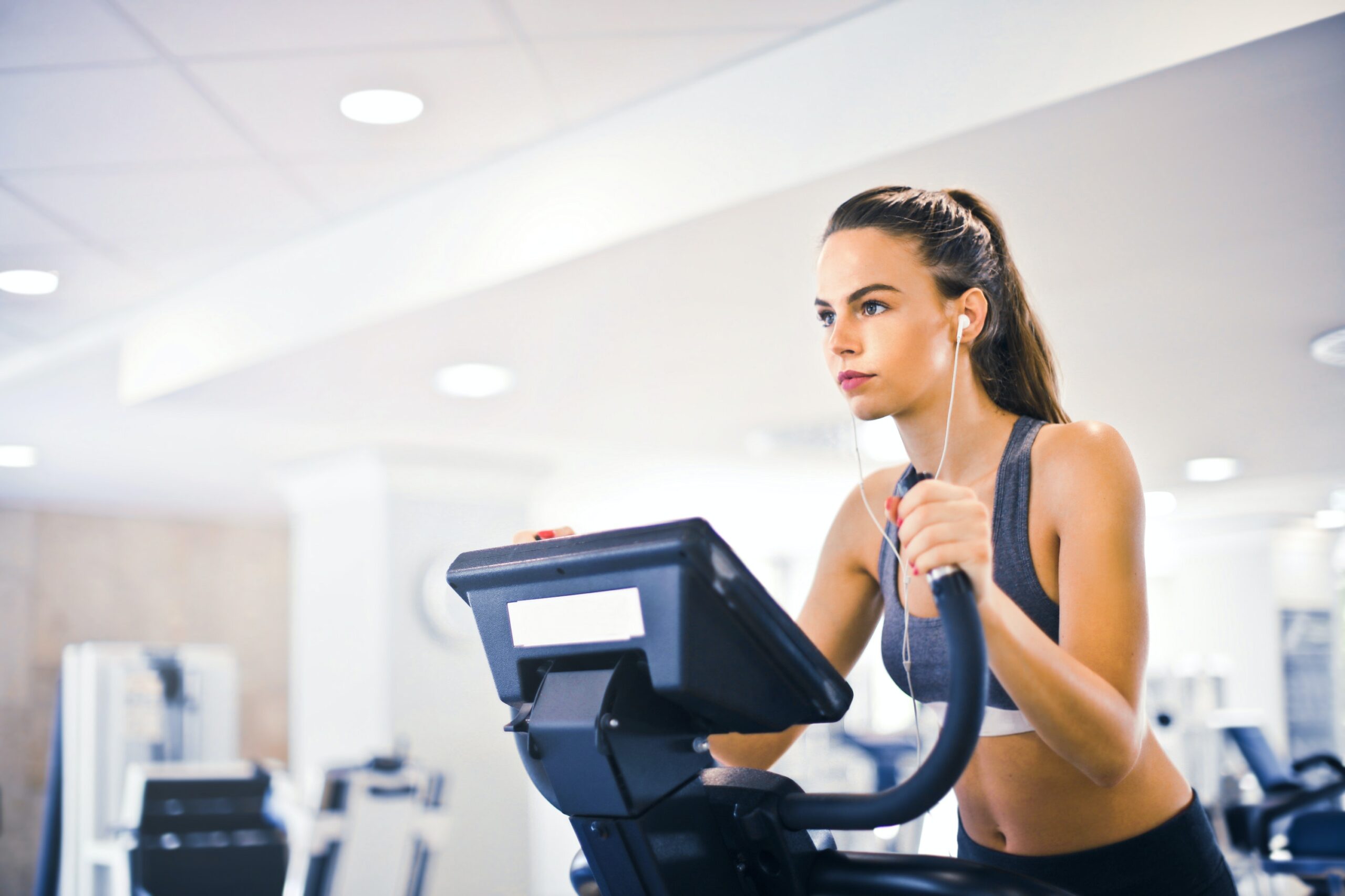 A women riding an exercise bike as part of a primary care routine